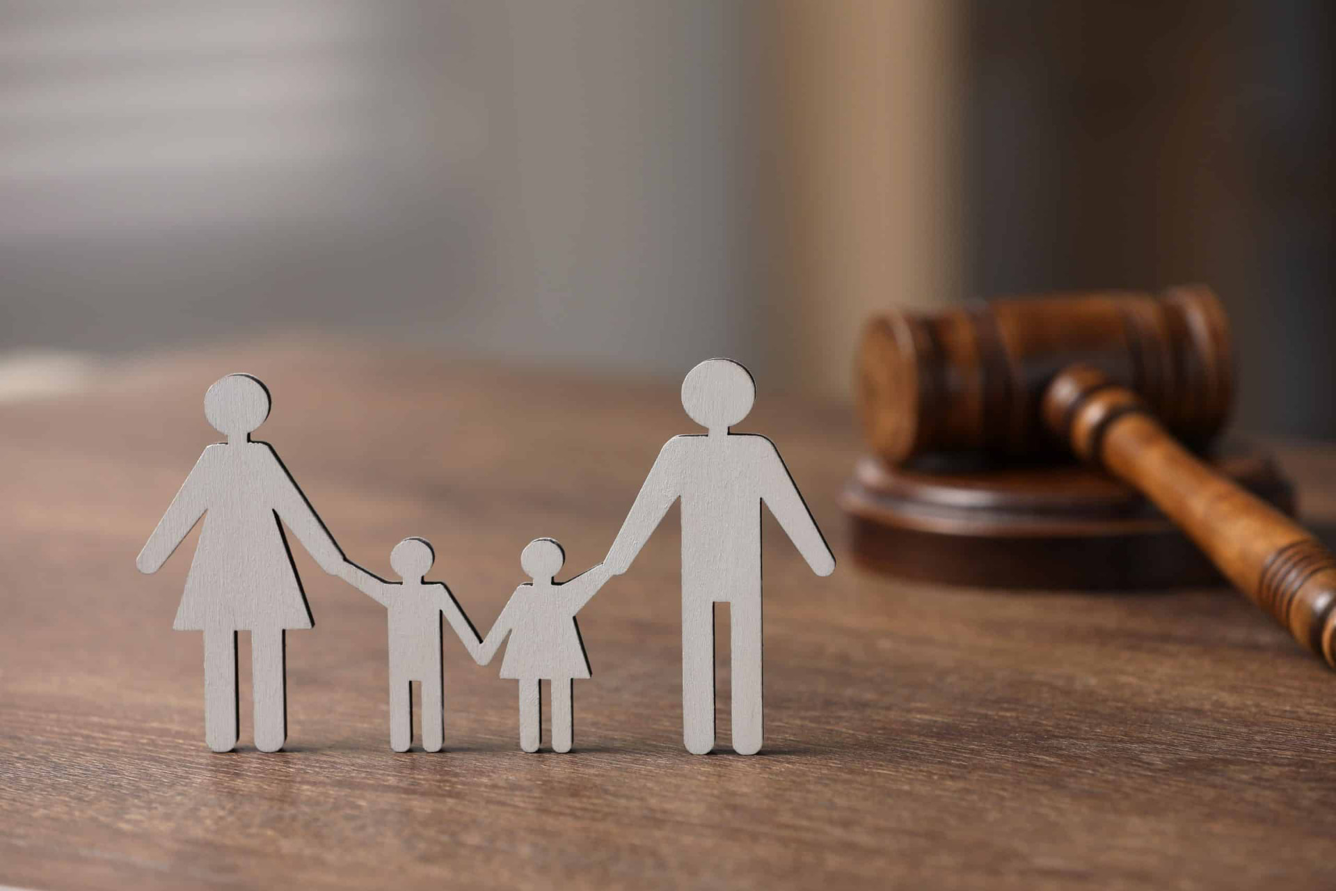 Family figures in front of a gavel, representing family law